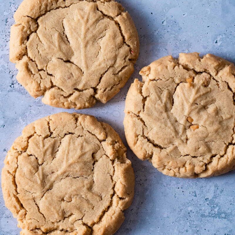 Dairy-free Peanut Butter Cookies from Grandma's Cookies, featuring three classic cookies with our traditional criss-cross pattern and crackly top texture. Each shows our signature hand-scooped style and golden peanut butter color.