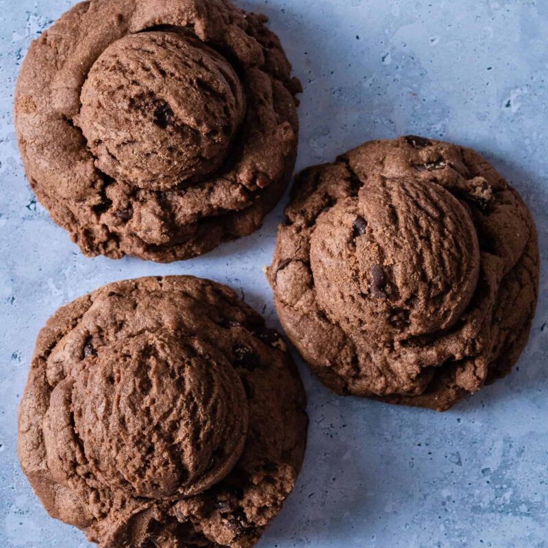 Double Chocolate Chip Cookies from Grandma's Cookies, showing three rich chocolate cookies with chocolate chips baked into dark cocoa dough. Each features our signature hand-scooped texture and fudgy appearance.