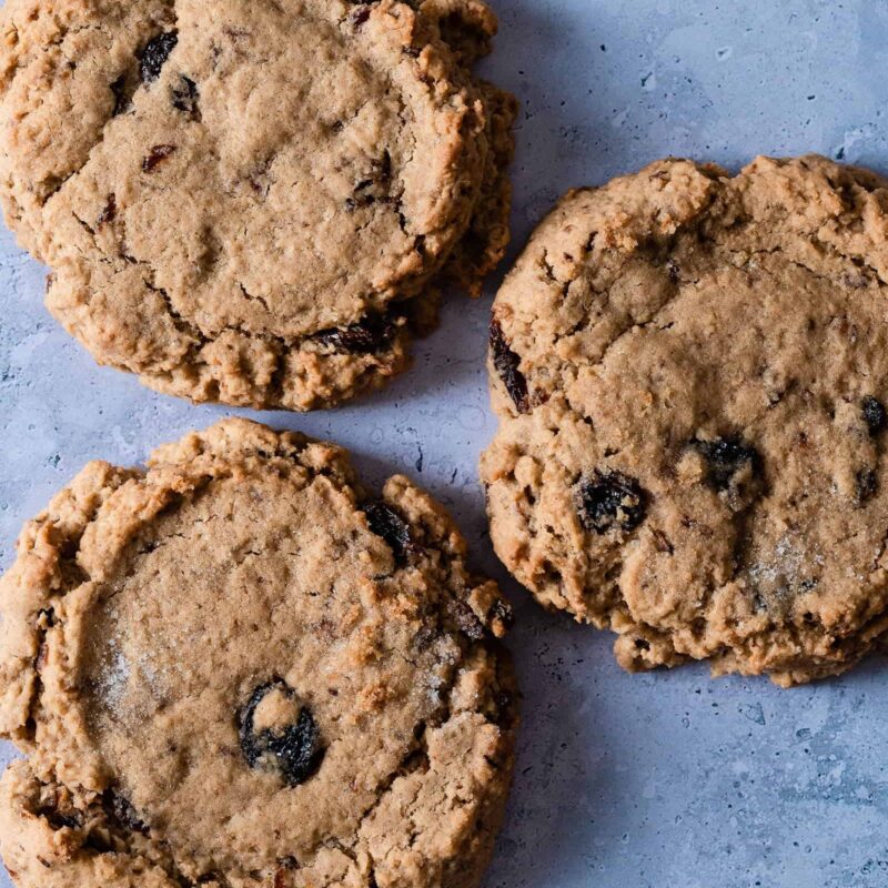 Freshly baked Oatmeal Raisin Cookies from Grandma's Cookies, featuring a soft, chewy texture and golden-brown color, with visible oats and plump raisins throughout.