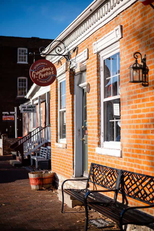 The historic brick storefront of Grandma’s Cookies, established in 1976, located on Main Street in St. Charles, Missouri. The entrance features a vintage-style hanging sign and charming decor, inviting passersby to enjoy freshly baked, one-of-a-kind cookies.